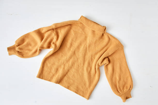 istock knitted yellow sweater on white table wooden 1175936418