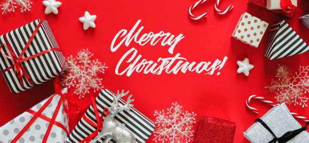 istock Flat Lay Christmas or party background with gift boxes, ribbons, decorations in silver, red and black colors. Flat lay, top view, xmas on red background long banner 1175937955