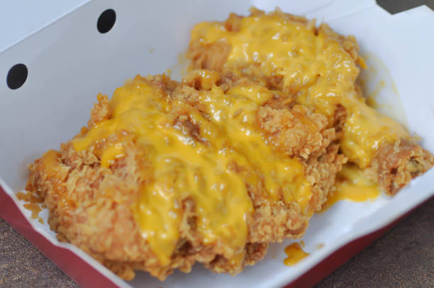 istock fried chicken, deep fried chicken with cheese topping 1175938529