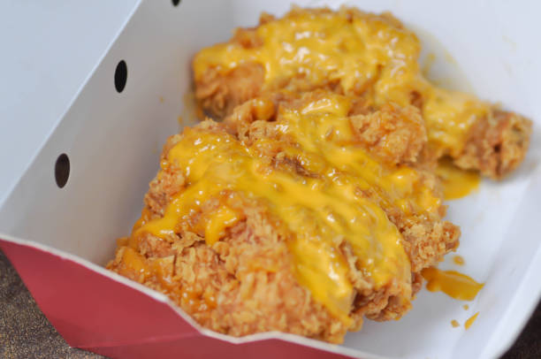 istock fried chicken, deep fried chicken with cheese topping 1175938531