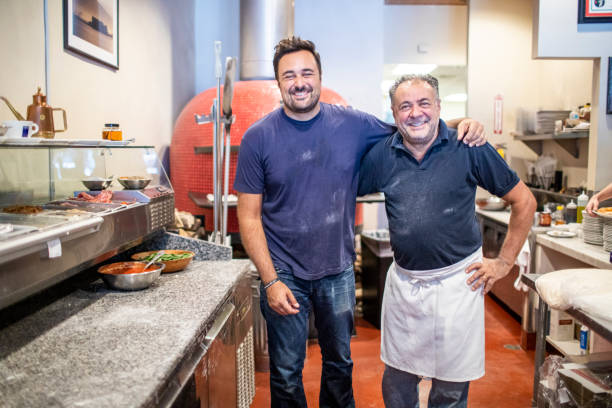 father and son at their pizzeria - pizzeria imagens e fotografias de stock