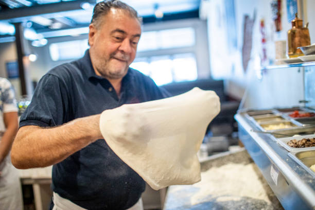 Senior Italian Man Working Pizza Dough A family owned Pizzeria italian ethnicity stock pictures, royalty-free photos & images