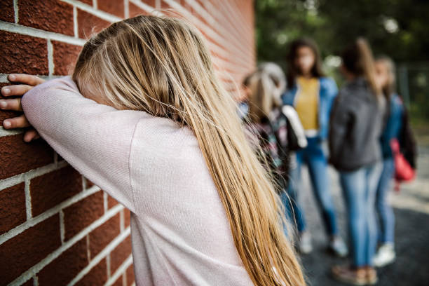 istock sad intimidation moment Elementary Age Bullying in Schoolyard 1175943745