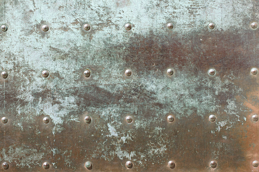 Metal plate covers with verdigris. Old metal texture with rivets pattern.