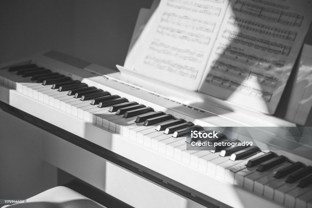 Closeup photo of electronic white piano at home Closeup photo of electronic white piano at cosy home Learning Stock Photo