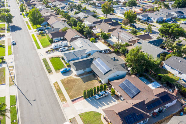 Aerial Neighborhood with Solar Panels A neighborhood in southern California where many homes have solar panels installed housing development photos stock pictures, royalty-free photos & images