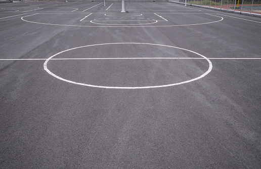Basketball court lines, center, white background, daylight in school, closeup