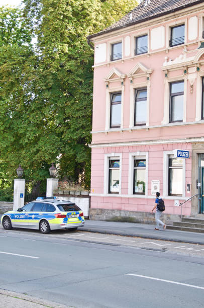 German police patrol vehicle parked outside a pink colour police station in Dortmund Aplerbeck - Germany German police patrol vehicle parked outside a pink colour police station in Dortmund Aplerbeck - Germany riot police stock pictures, royalty-free photos & images