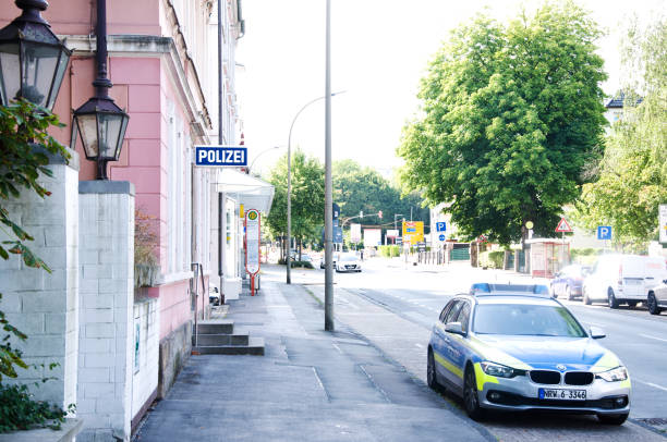 German police patrol vehicle parked outside a pink colour police station in Dortmund Aplerbeck - Germany German police patrol vehicle parked outside a pink colour police station in Dortmund Aplerbeck - Germany riot police stock pictures, royalty-free photos & images
