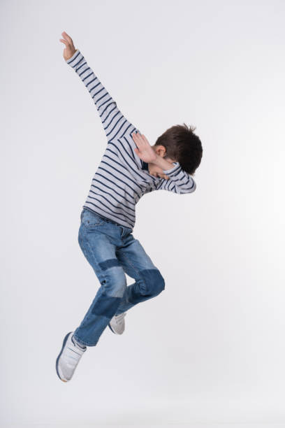 istock The happy boy  jumping on a white 1175951287