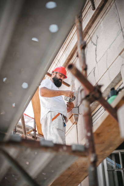 istock Man worker standing on scaffolding and restore old building facade 1175951721