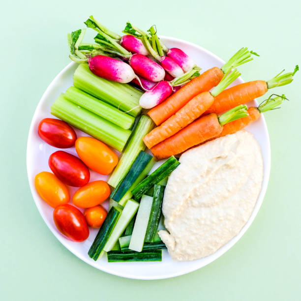 Fresh Vegetable Crudite Platter With Hummus Fresh Vegetable Crudite Platter With Hummus and Baby Carrots, Radishes, Cucumber, Celery and Tomatoes Veggie Sticks with Hummus stock pictures, royalty-free photos & images