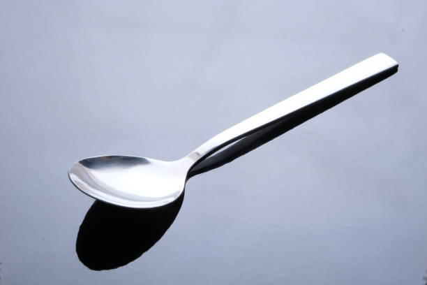 istock Empty steel Spoon isolated on black background 1175953080
