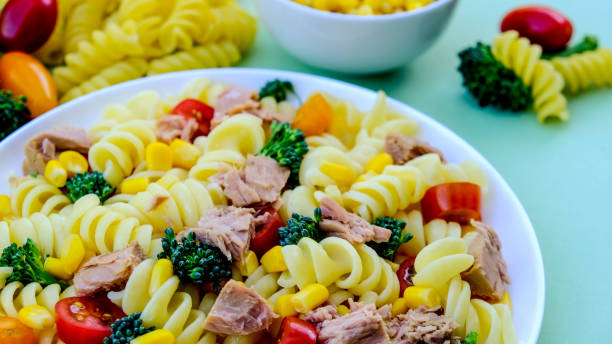 Tuna and Sweetcorn Healthy Pasta Salad Tuna and Sweetcorn Healthy Pasta Salad With, Broccoli Florets, Cherry Tomatoes and Fusilli Pasta seafood salad stock pictures, royalty-free photos & images