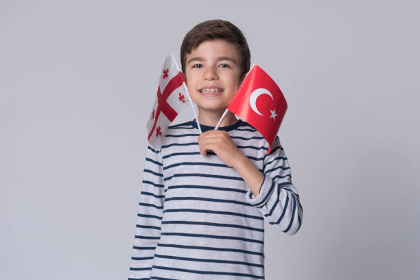 istock Happy boy holding Turkish and Georgian flag 1175955444