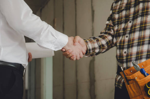 istock construction worker team contractor shaking hands with engineer after finishing up business meeting to start up project contract in construction site building, teamwork, partnership, industry concept 1175960442