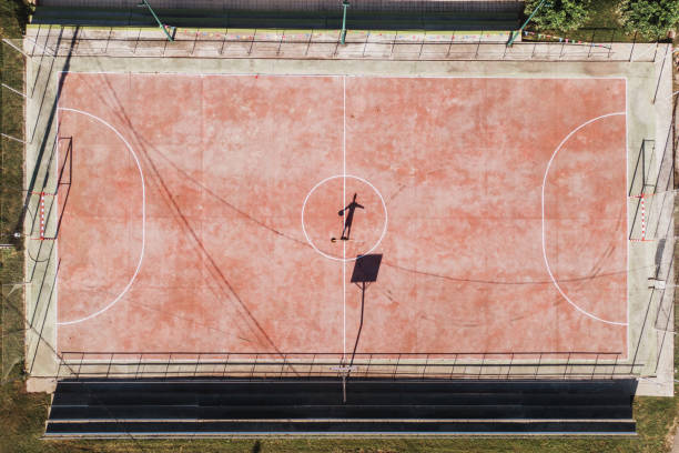 istock Person playing basketball alone as seen from above 1175961754