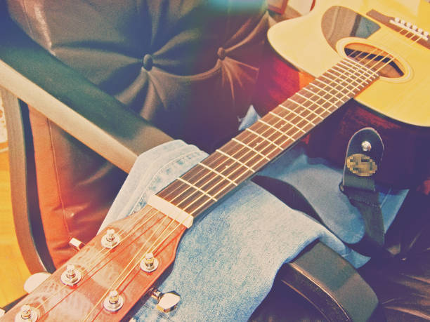 Young child playing guitar. Vignetted.More:
