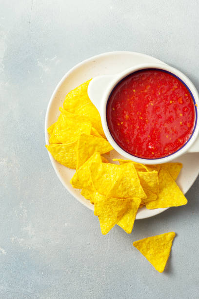 istock From above view of nachos plate with tomato sauce 1175962916