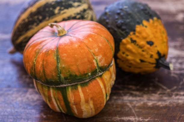 istock Autumn background, decorative pumpkins at wood board 1175963872
