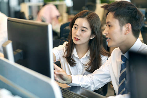 istock Focused Young Chinese Business Colleagues Sharing Computer 1175964011