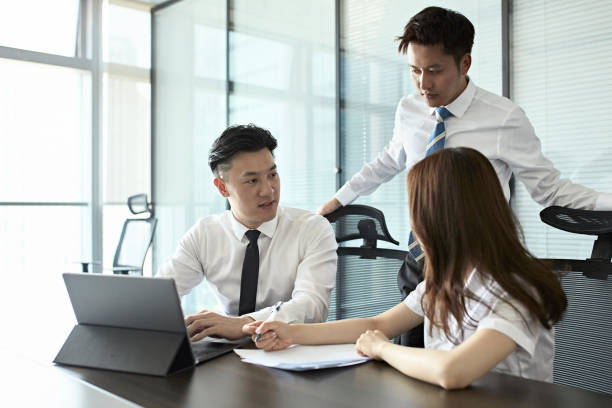 istock Chinese Business People Discussing Ideas in Conference Room 1175964022