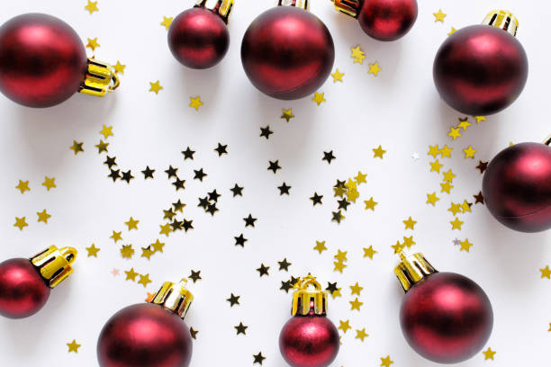 istock Red Christmas balls with golden stars on white backgound 1175964113