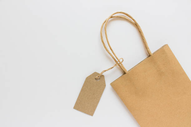 istock Blank mockup label tag kraft paper present shopping bag on white background 1175964382