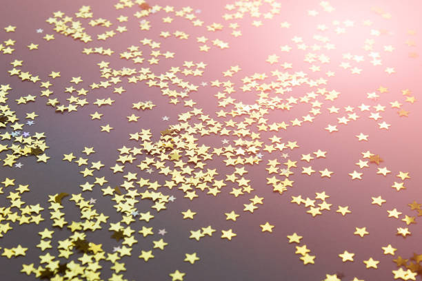 istock Festive background with shiny randomly arranged golden stars 1175964556