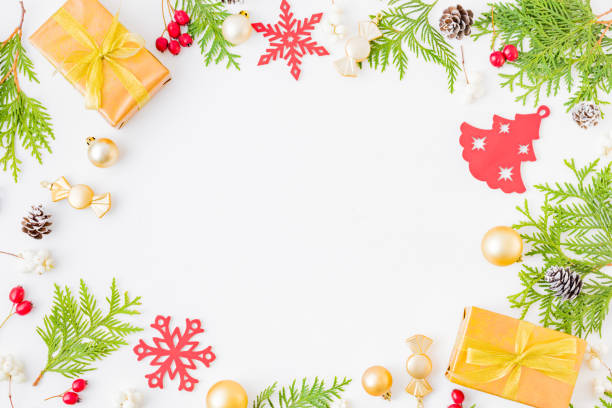 istock Flat lay frame with evergreen tree branch, christmas decorations and gift box on a white background 1175965277