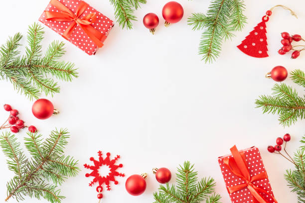 istock Flat lay frame with evergreen tree branch, christmas decorations and gift box on a white background 1175965280