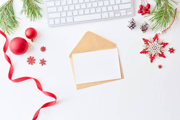 istock Mockup white greeting card and envelope, pine branches and keyboard with christmas decorations on a white background 1175965311