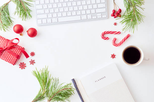 istock Flat lay christmas home office desk with pine branches and keyboard, christmas decorations  on a white background 1175965314