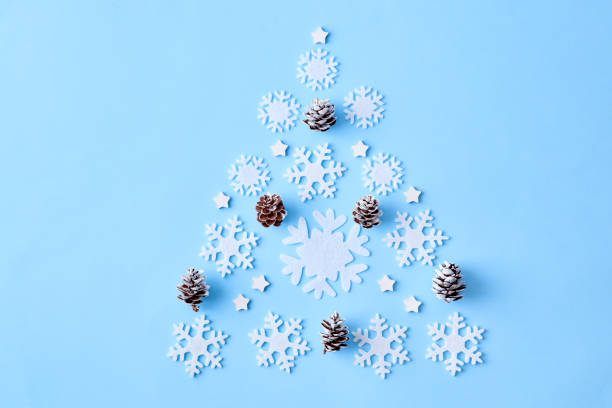 istock Flat lay composition with christmas tree of white snowflakes on a blue background 1175965338