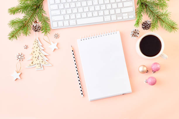 Mockup white notebook with spruce branche and keyboard, christmas decorations on a color background