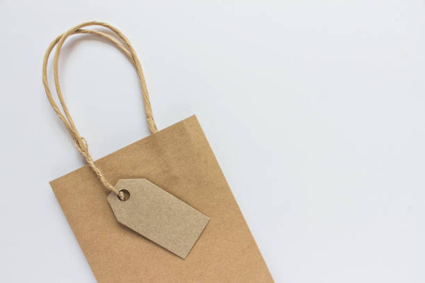 istock Blank mockup kraft paper present shopping bag on white background 1175965358