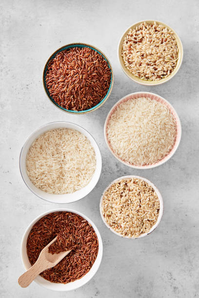 istock Rice variety in a various bowls. Wild red rice, brown rice, white basmati rice. Top view 1175973259