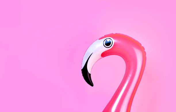 istock Summer fun concept with pink inflatable flamingo head on pink background with copy space 1175974122