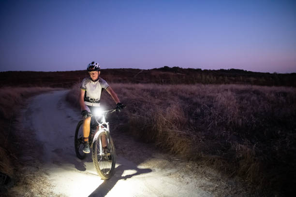 istock Night MTB Rider With A Light At Sunset 1175974271