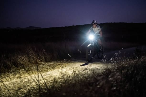 istock Night MTB Rider With A Light At Sunset 1175974300