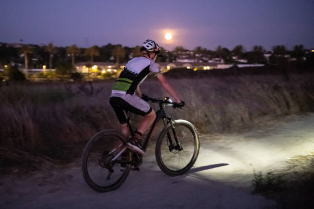 istock Night MTB Rider With A Light At Sunset 1175974368
