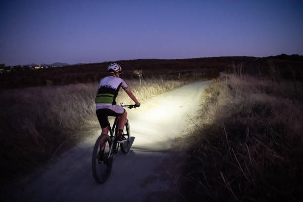 istock Night MTB Rider With A Light At Sunset 1175975585