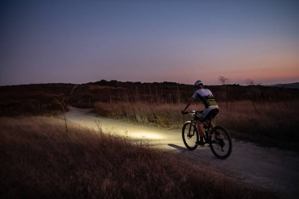 istock Night MTB Rider With A Light At Sunset 1175975728