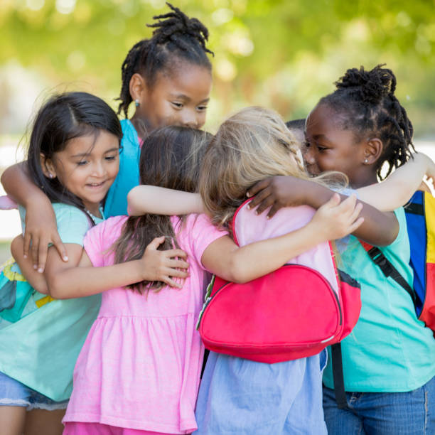 istock Group of kindergarteners embrace each other 1175975779