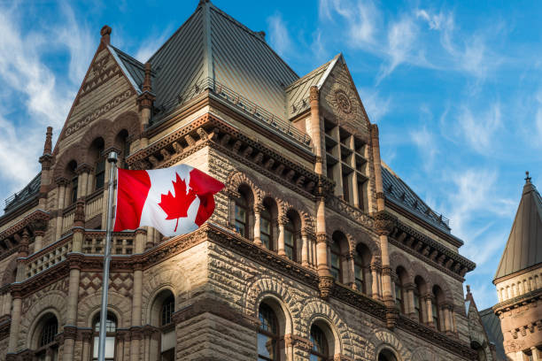 City Hall The Canadian flag flies before the Old City Hall in Toronto, Canada. ontario flag stock pictures, royalty-free photos & images