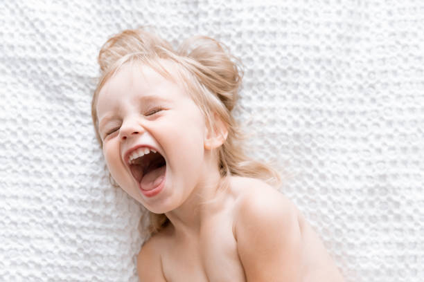 Little Happy Kid Laughing on White Background. Children's Concept. Motherhood