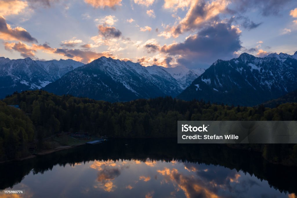 Sunrise at Freibergsee lake near oberstdorf reflection of clouds on the water surface of the lake Allgau Stock Photo