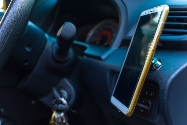 Smartphone in a car use for Navigate or GPS. Driving a car with Smartphone in holder. Mobile phone Blank empty screen. copy space. Empty space for text. car interior details. High resolution image gallery.