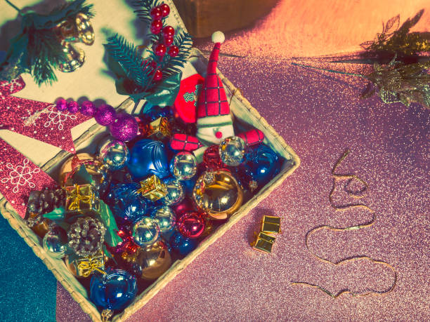 istock wicker box with pile of multicolored Christmas decorations on a bright background 1175983959