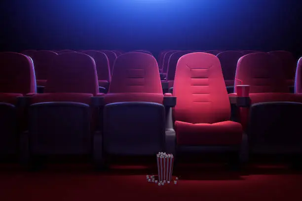 Photo of Row of empty red cinema seats
